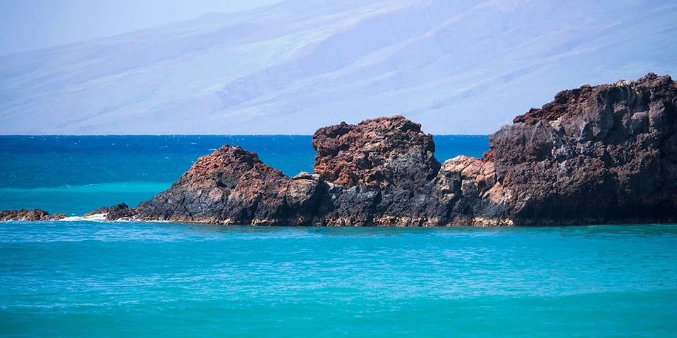 Puʻu Kekaʻa (Black Rock) lava headland at the north end of Kaʻanapali Beach with Lānaʻi behind